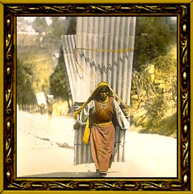 Woman carrying large corrugated sheets